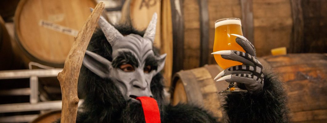 Krampus looking to a beer glass